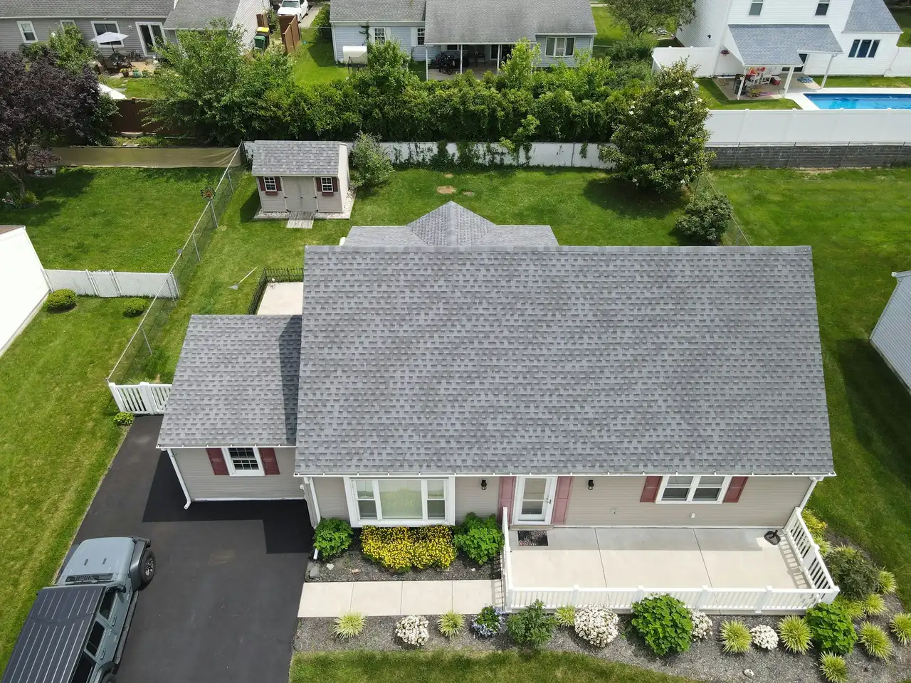 Aerial view of a home with a new gray shingle roof
